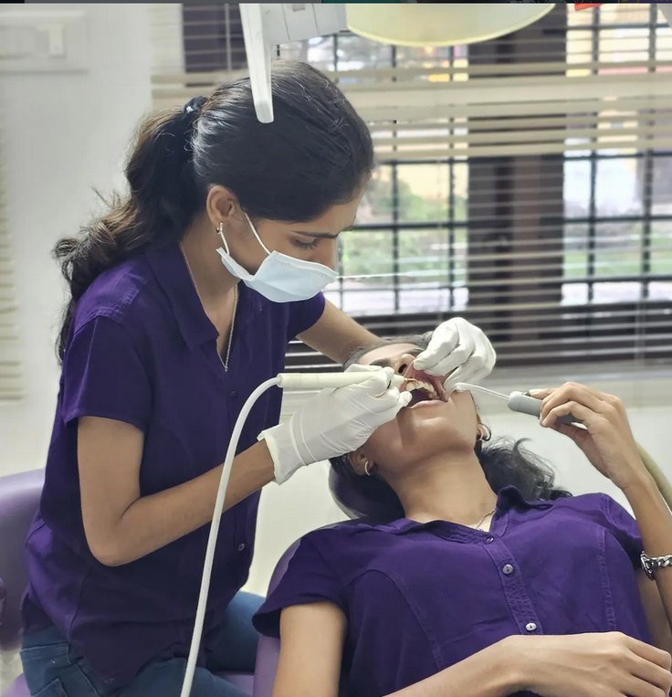 Dentist treating a patient at Dr. Vidhu's 32